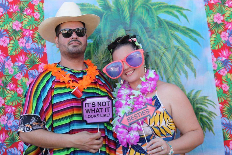 Photo booth rental in Orange open-air setup with professional lighting, props, and 4x6 prints