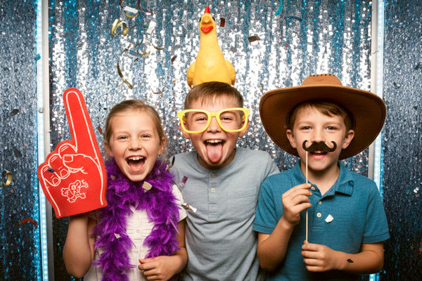 Photo booth rental in Fullerton open-air setup with professional lighting, props, and 4x6 prints
